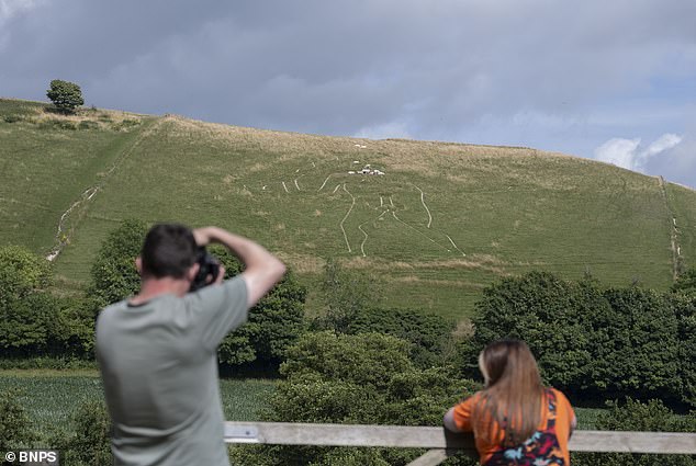Restoration crew applies 17 tonnes of chalk to Britain's giant statue.